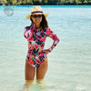 Combi Surf Manches Longues Push-Up Floral Palmier HELICONIA - face avant plan large piscine naturelle